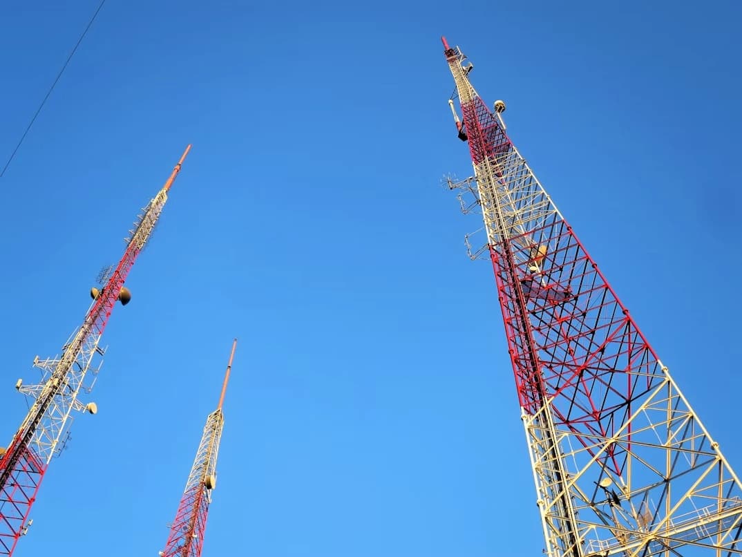 Telecommunications tower project under bright sky